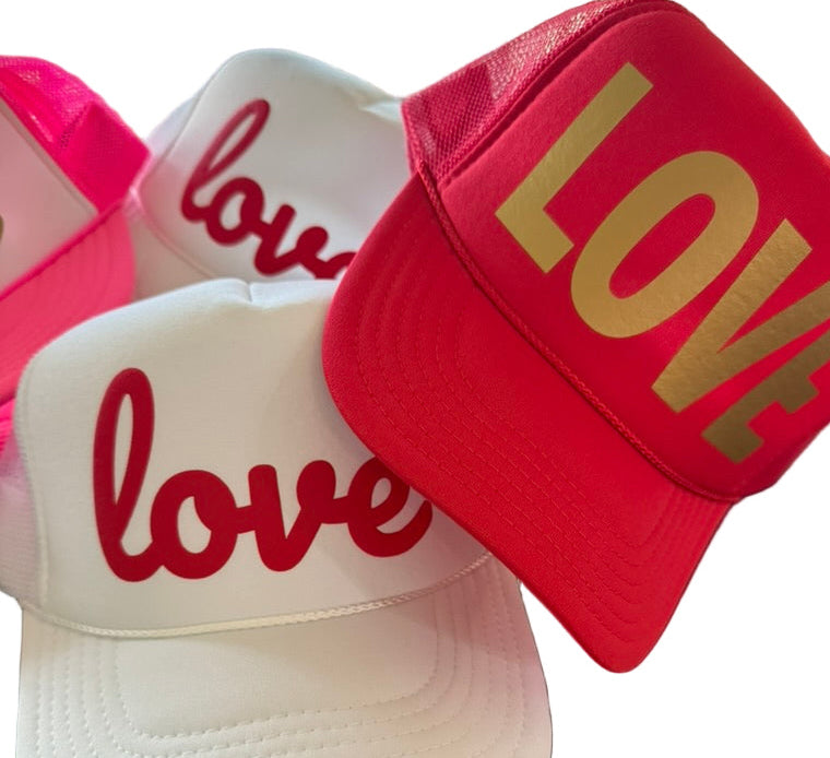 Three caps with 'love' text in different colors on a white background