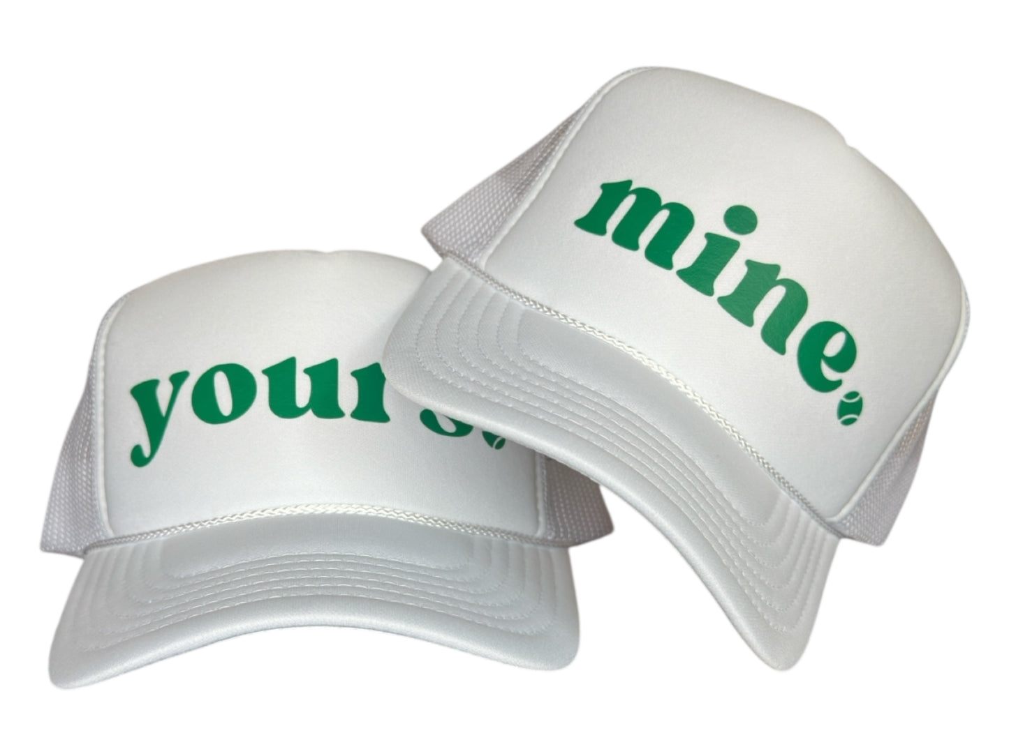 Two white caps with green text 'mine' and 'your' on a white background