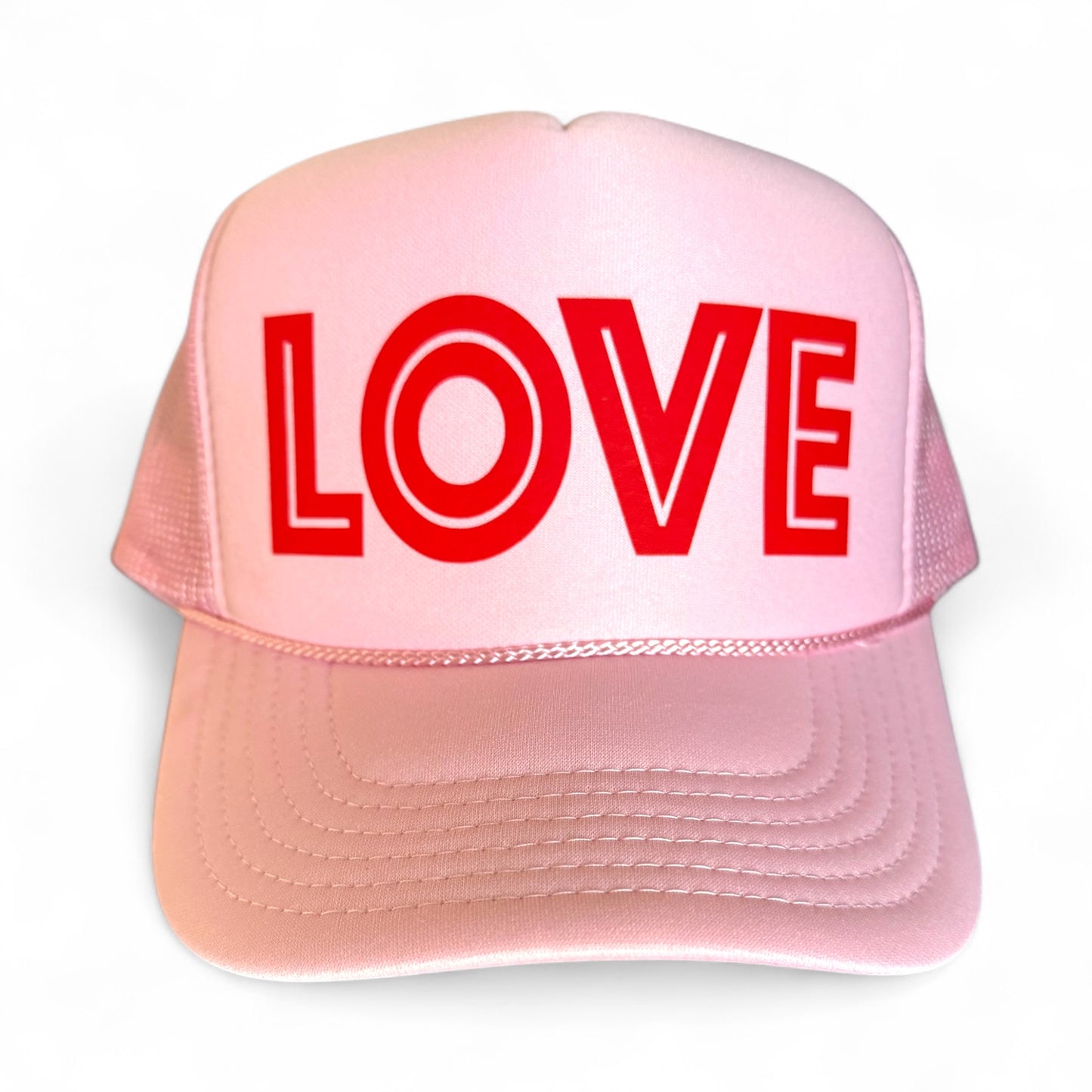 Pink cap with 'LOVE' in red on a white background