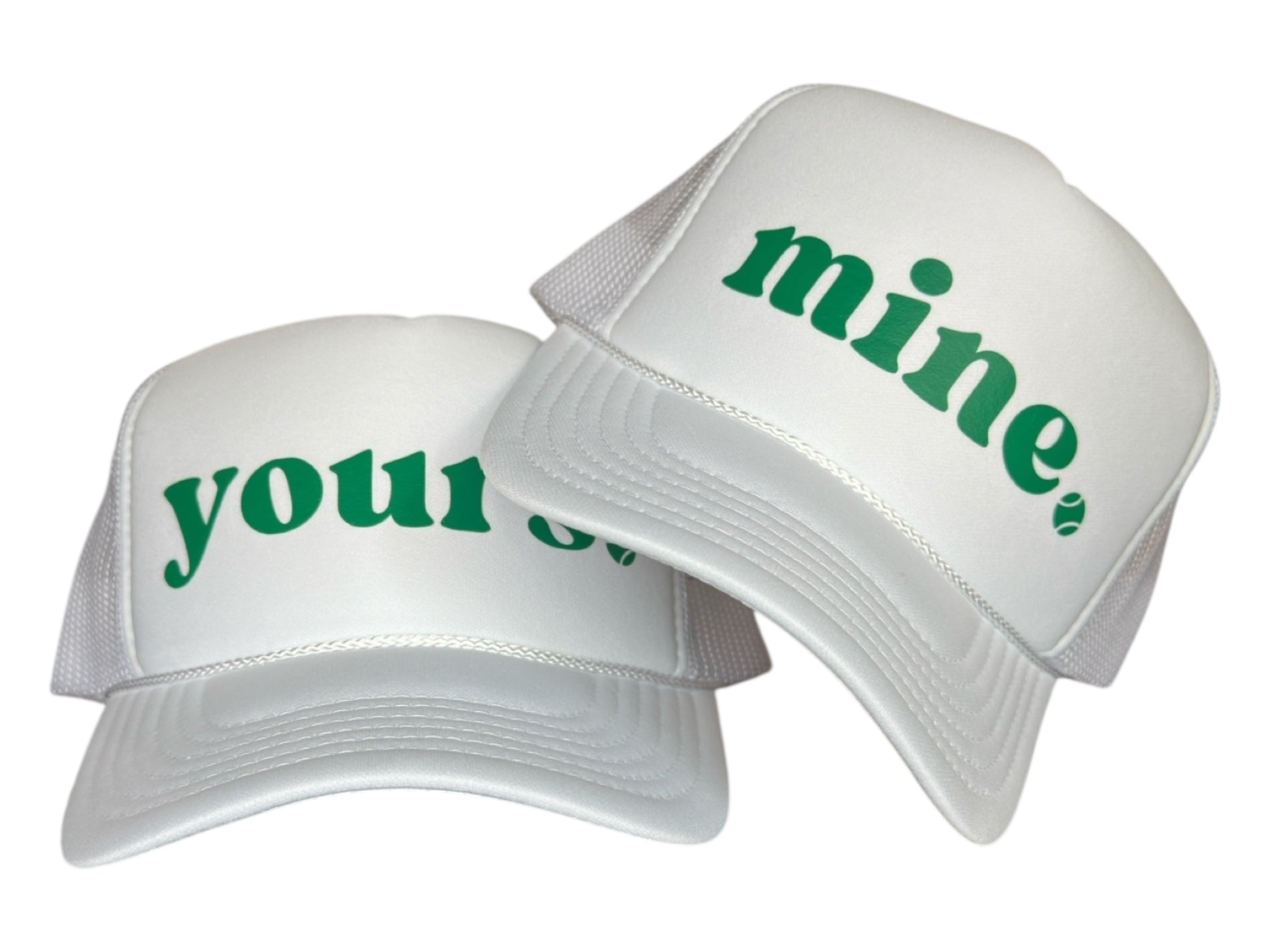 Two white caps with green text 'mine' and 'your' on a white background