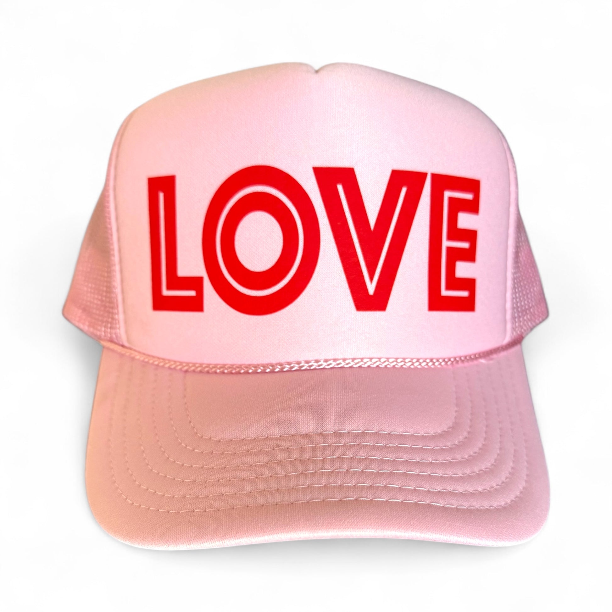 Pink cap with 'LOVE' in red on a white background