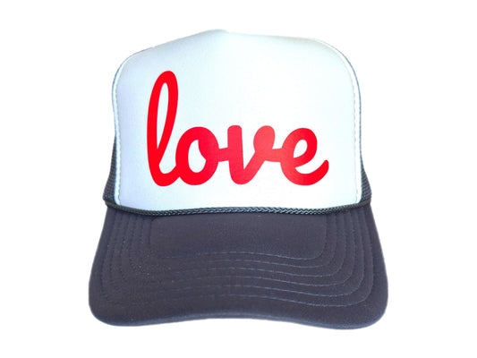 Navy and white trucker hat with bold red love script text on foam front