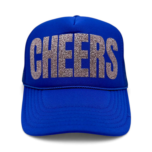 Royal blue foam trucker hat with large silver glitter “CHEERS” text on the front, festive party snapback.
