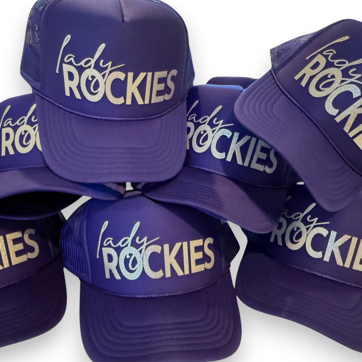 Purple caps with 'lady ROCKIES' text on a white background