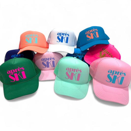 Set of colorful “après SKI” foam trucker hats in green, mint, pink, coral, white, blue, and other bright shades, fun winter ski party caps.