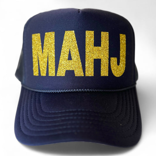 Custom stevi. trucker hat in navy with large, block, letters "MAHJ" in gold glitter. Perfect mahjong gift for  group or to elevate your tile game. 