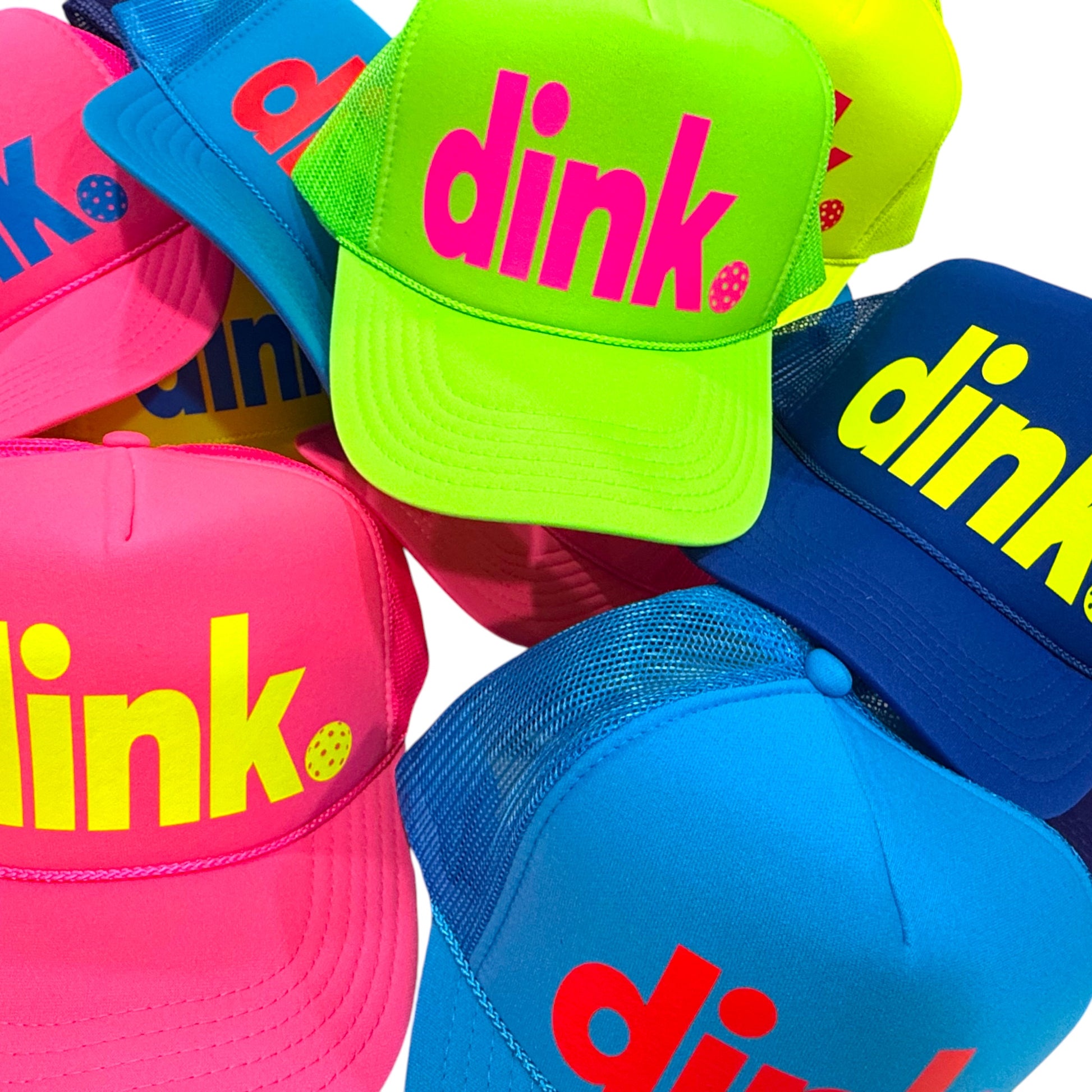 Colorful pickleball caps with 'dink' text in various neon colors. Accessorize your next pickleball match and bring swagger to the court. 