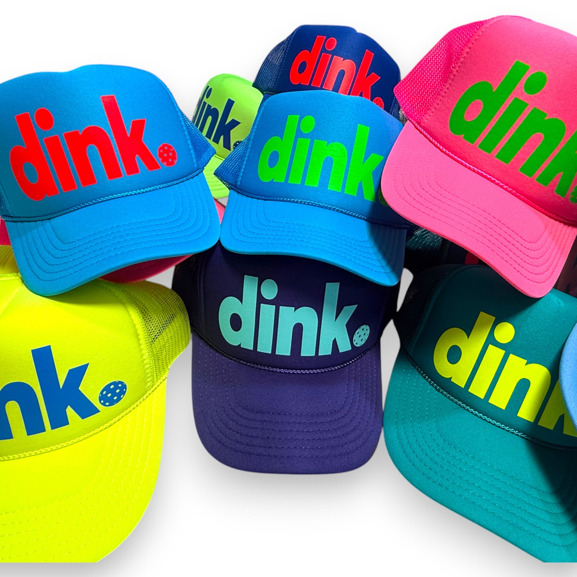 Assortment of pickleball trucker hats in variety of bright colors with "dink" logo nad pickleball. Great gift or team accessory!