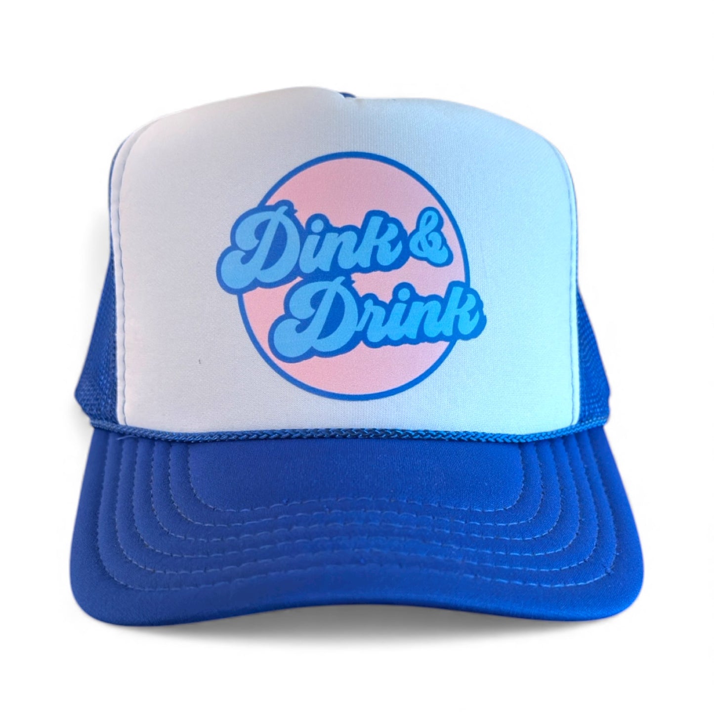 Pickleball trucker hat  in royal & white with "dink and drink" script retro logo in circle in pink, blue and royal by stevi. 