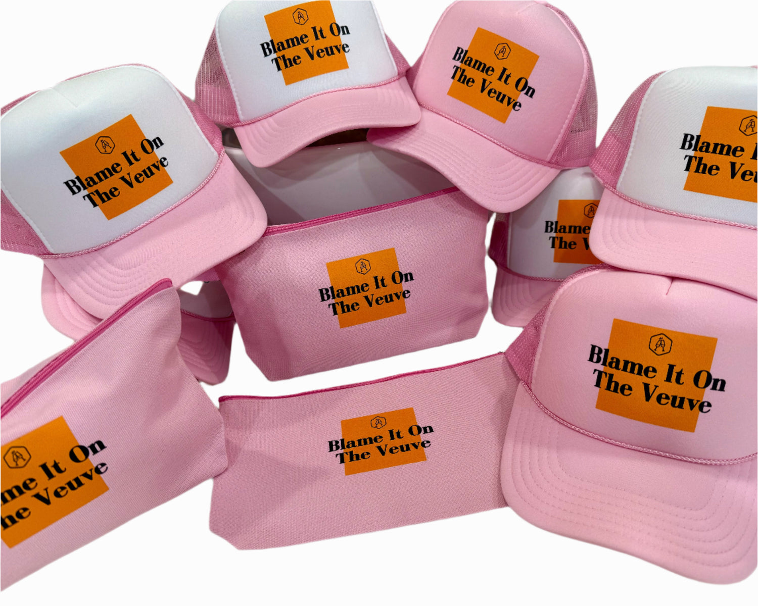 Pink caps with 'Blame It On The Veuve' text on a white background